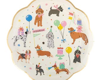May include: A white, scalloped-edge paper plate with a gold rim, decorated with cartoon dogs wearing party hats and holding balloons. The plate features the text "HOORAY YAY" and images of presents and a cake.