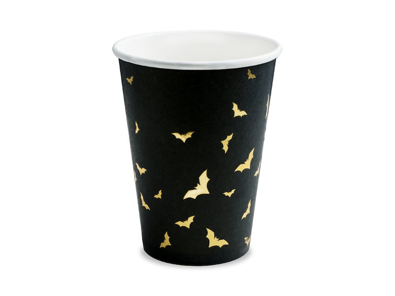 May include: Black paper cup with a gold bat pattern.