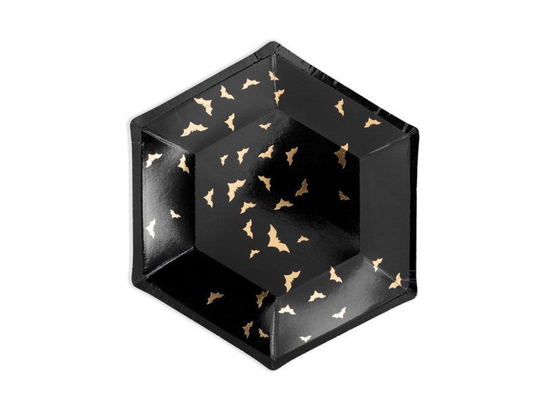 May include: Black hexagonal paper plates with a gold bat pattern.