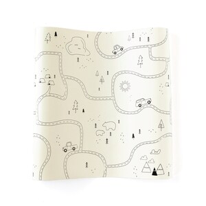May include: A black and white illustration of a road map with cars, trees, mountains, a sun, and bears. The map is on a beige background.