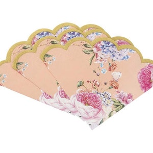 May include: A set of six peach-colored paper napkins with a floral design. The napkins have scalloped edges and a gold trim.