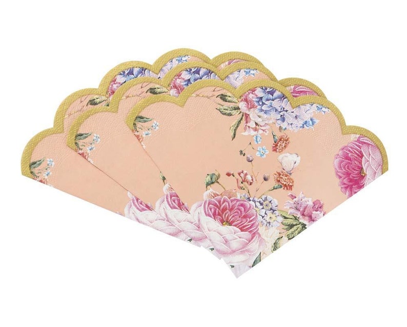 May include: A set of six peach-colored paper napkins with a floral design. The napkins have scalloped edges and a gold trim.