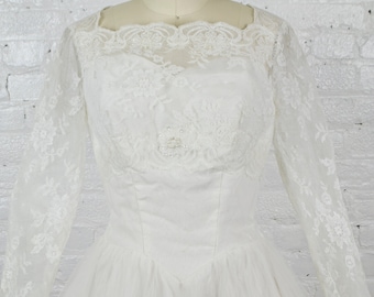 1950s tulle and lace princess ballgown wedding dress with long sleeves . small