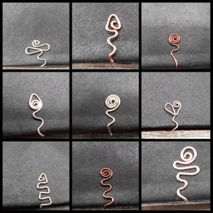 May include: Nine different wire designs, each with a unique shape and style. The designs are made of copper wire and are arranged in a grid pattern.