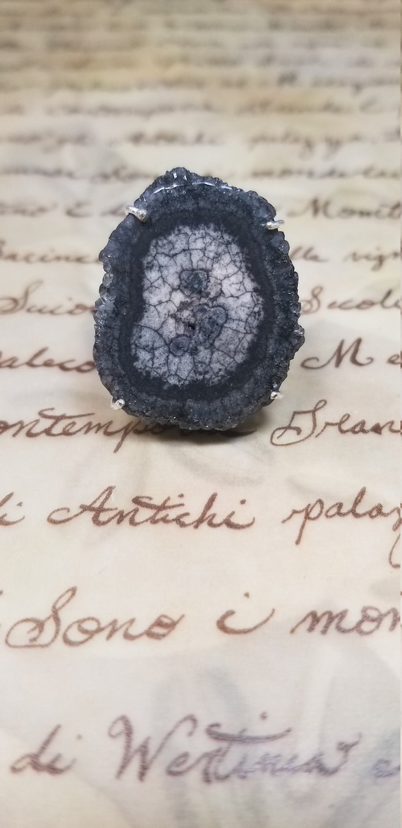 A one-of-a-kind black solar slice cocktail ring — actual geology-meets-jewelry OOAK craft that you genuinely cannot find at any chain store.