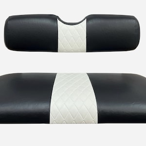 May include: Black and white golf cart seat cushions with a diamond pattern on the white section.