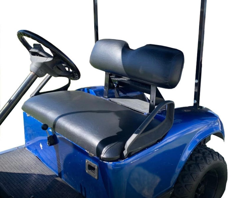 May include: A blue golf cart with a black leather seat and a black headrest. The cart has a black steering wheel and a black roll bar.