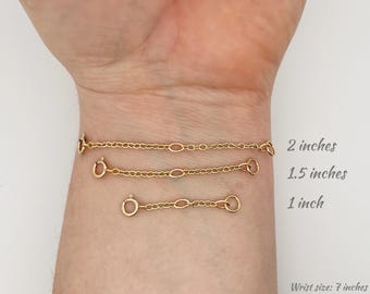 May include: Three gold chain bracelet extenders, measuring 1 inch, 1.5 inches, and 2 inches. The extenders are shown on a wrist with a 7 inch circumference.