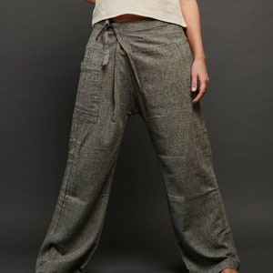 May include: Gray wrap pants with a tie at the waist. The pants are made of a soft, comfortable fabric and have a relaxed fit.