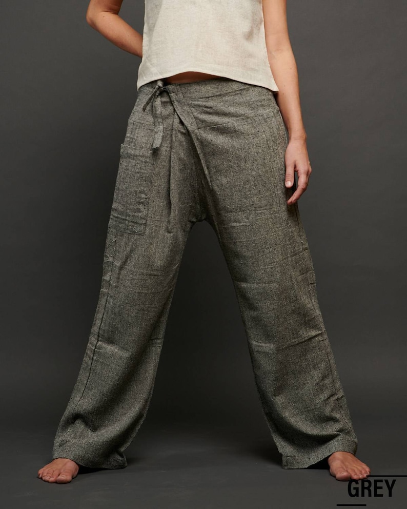 May include: Gray wrap pants with a tie at the waist. The pants are made of a soft, comfortable fabric and have a relaxed fit.