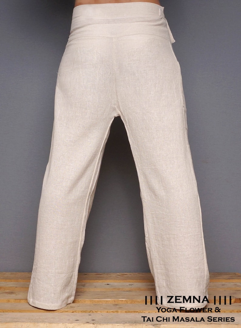 May include: A pair of off-white linen pants with a wide waistband and a loose, flowing fit. The pants are designed for yoga, tai chi, and other forms of exercise. The text "ZEMNA YOGA FLOWER & TAI CHI MASALA SERIES" is printed on the bottom of the image.