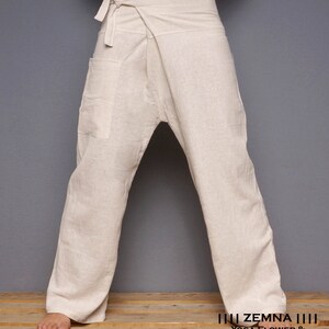 May include: A pair of off-white linen pants with a wrap-around style and a single pocket on the left side. The pants are tied at the waist with a fabric sash.  The pants are called "Yoga Flower & Tai Chi Masala Series" by "ZEMNA".