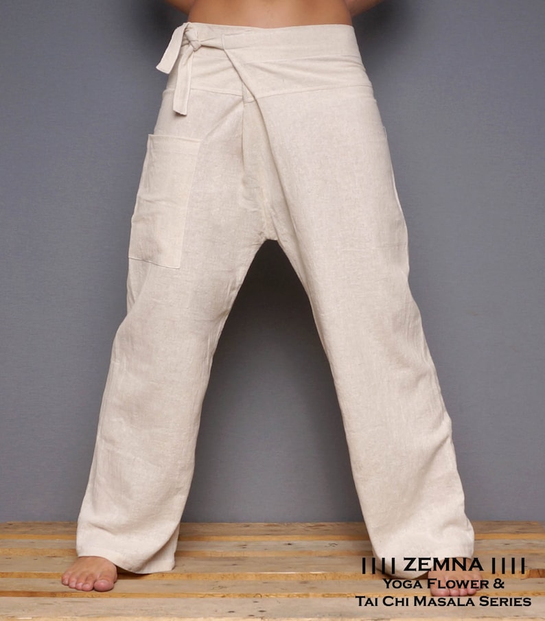 May include: A pair of off-white linen pants with a wrap-around style and a single pocket on the left side. The pants are tied at the waist with a fabric sash.  The pants are called "Yoga Flower & Tai Chi Masala Series" by "ZEMNA".