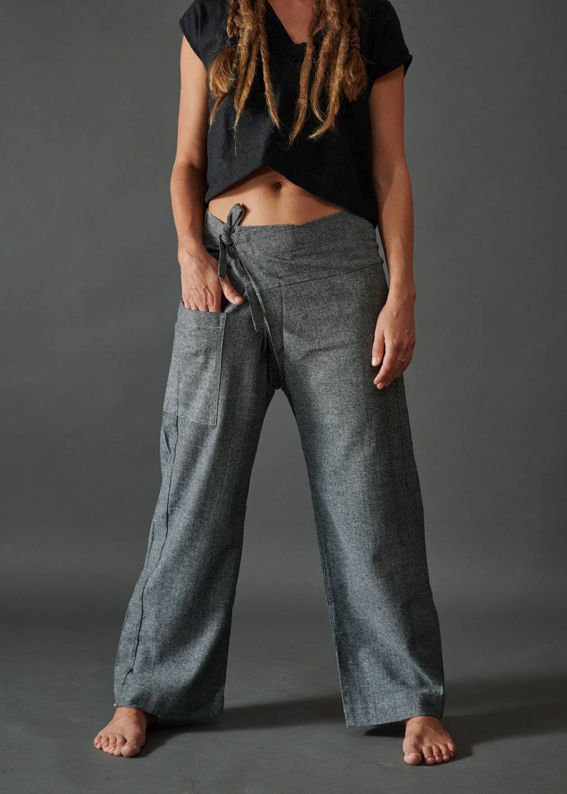 May include: Gray wrap pants with a tie at the waist. The pants have a large pocket on the left side.