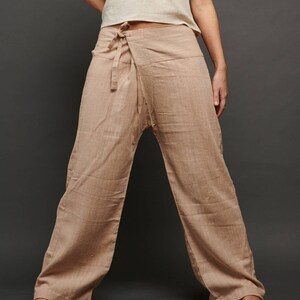 May include: A pair of wide-legged pants in a light brown color. The pants are made of a soft, natural fabric and have a wrap-around style with a tie at the waist. The pants are called "Natural Cream".