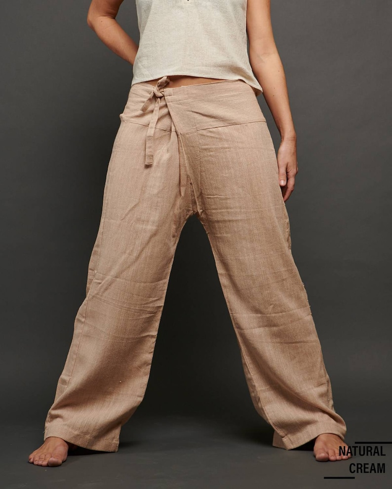 May include: A pair of wide-legged pants in a light brown color. The pants are made of a soft, natural fabric and have a wrap-around style with a tie at the waist. The pants are called "Natural Cream".