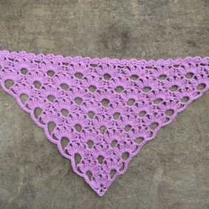 May include: A purple crocheted triangular shawl with a lacy pattern.