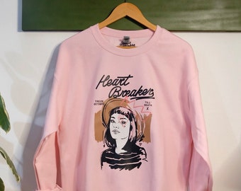 Sweat-shirt rose Heartbreaker illustré graphic