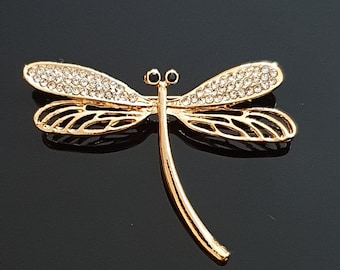 Gold coloured dragonfly brooch.