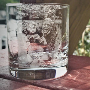 Peut inclure: Un verre en verre transparent avec une image grav&eacute;e d'un homme et d'un jeune enfant. L'image montre l'homme souriant et tenant l'enfant, qui porte un t-shirt sur lequel est &eacute;crit "Dylan".