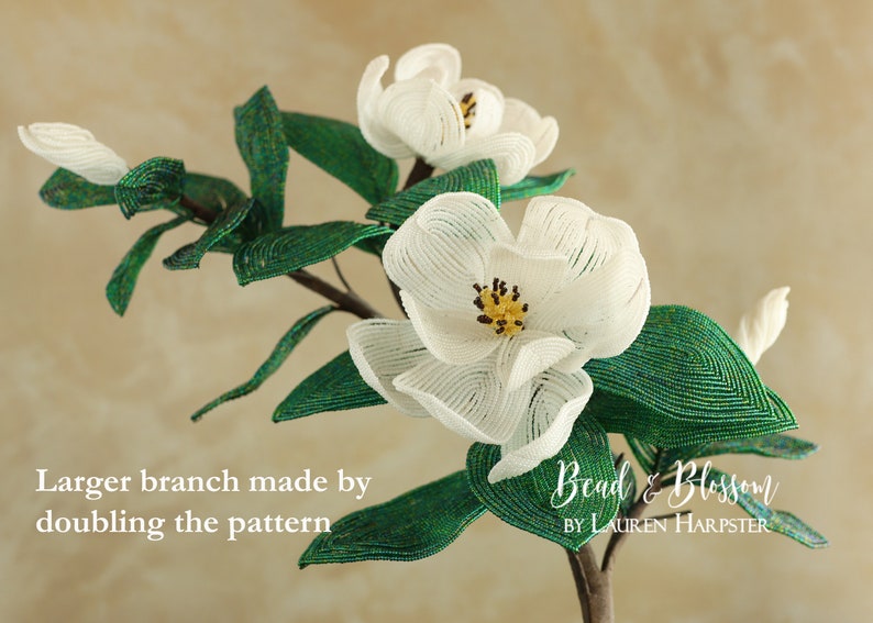 May include: A beaded magnolia flower branch with white blossoms and green leaves. The branch is made by doubling the pattern. The text "Bead & Blossom by Lauren Harpster" is visible in the image.