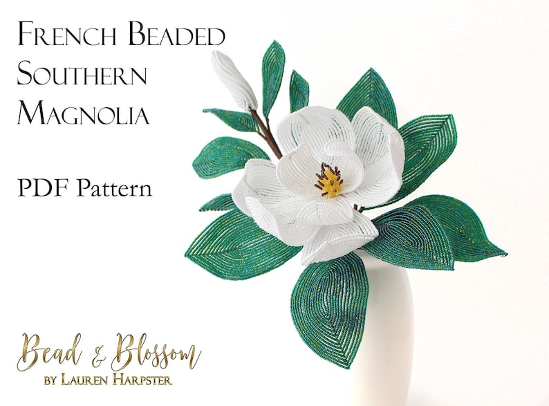 May include: A white beaded Southern Magnolia flower with green beaded leaves in a white vase. The image includes the text "French Beaded Southern Magnolia PDF Pattern Bead & Blossom by Lauren Harpster".