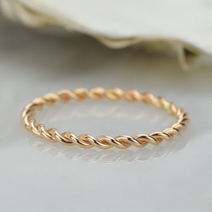 Peut inclure: Une délicate bague en or avec un design de corde torsadée.