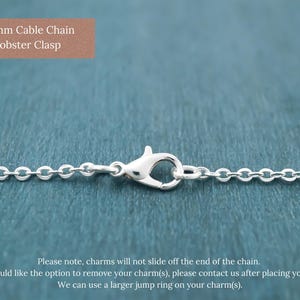 May include: A silver-coloured cable chain featuring a 12mm lobster clasp. The text in the image reads: 2 x 1.5 mm Cable Chain 12mm Lobster Clasp. Please note, charms will not slide off the end of the chain. If you would like the option to remove your charm(s), please contact us after placing your order. We can use a larger jump ring on your charm(s).