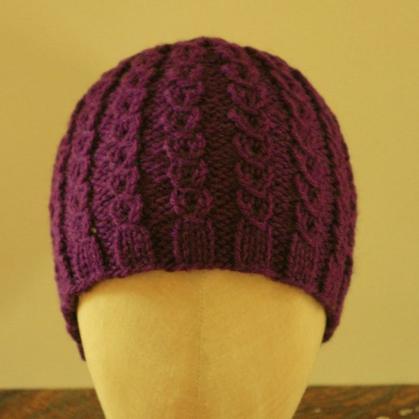 Handknit cable pattern beanie/slouch hat in easy-care wool blend. Child 3-10 years old. Purple.