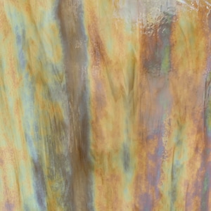 May include: A close-up of a textured, iridescent surface with shades of green, brown, and gold. The surface has a metallic sheen and appears to be made of metal or glass.