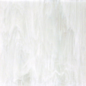 May include: A square piece of white stained glass with a flowing, marbled appearance. The glass has a translucent quality, with streaks and swirls of white creating a dynamic, textured surface. Ideal for craft projects.