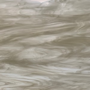 May include: A sheet of textured glass with a flowing, marbled pattern. The glass features a blend of off-white and light gray tones, creating a soft, cloudy appearance. The design resembles swirling water or smoke.