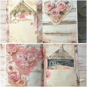 May include: A handmade journal with a romantic, vintage aesthetic. The journal features a heart-shaped lace embellishment with pink paper roses. The pages have a floral design and a decorative envelope. The journal is perfect for writing or scrapbooking.