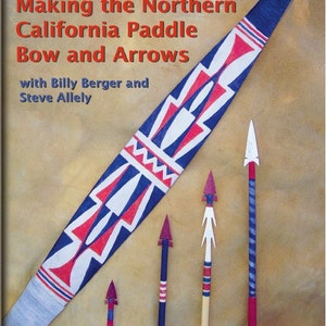 May include: A book cover with the title "Primitive Pathways Presents: Making the Northern California Paddle Bow and Arrows" with the subtitle "with Billy Berger and Steve Allely". The cover features a blue, red, and white paddle bow with a geometric design and four arrows with red, white, and blue fletching.