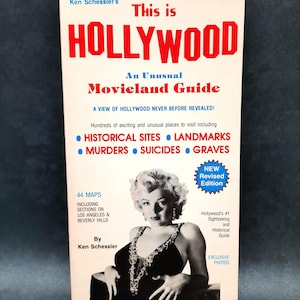 May include: A vintage travel guide titled "This is Hollywood" with a photo of Marilyn Monroe. The cover features red and blue text, advertising an unusual movieland guide with historical sites, landmarks, and exclusive photos.