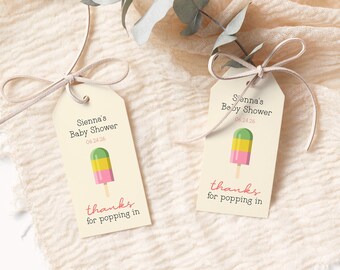 May include: Two cream-colored favor tags with a green, yellow, and pink popsicle illustration. The text on the tags reads "Sienna's Baby Shower" and "thanks for popping in".