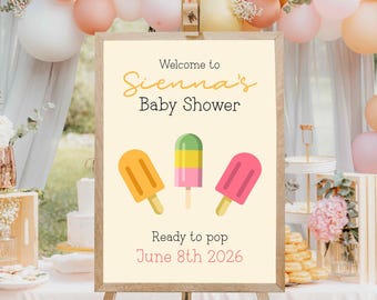 May include: A welcome sign for a baby shower with a popsicle theme. The sign is decorated with three colourful popsicles and the text "Welcome to Sienna's Baby Shower. Ready to pop June 8th 2026".