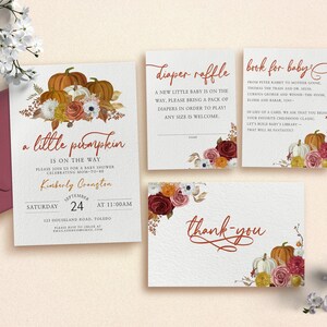 May include: A set of four printable cards for a baby shower. The cards are decorated with autumn-themed illustrations of pumpkins, flowers, and leaves in shades of orange, red, and yellow. The text on the cards reads "a little pumpkin is on the way", "diaper raffle", "book for baby", and "thank you".