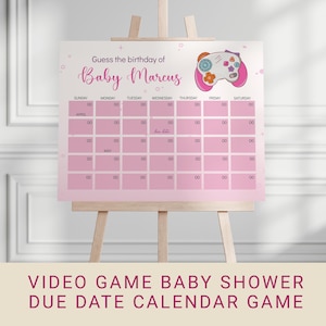 May include: A pink baby shower calendar game on a wooden easel. The calendar has a grid for guessing the baby's due date, with the text "Guess the birthday of Baby Marcus." A video game controller graphic is in the upper right.