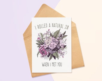 May include: A white card with the text "I rolled a natural 20 when I met you."  A purple and black 20-sided die with white numbers is surrounded by pink, white, and green flowers.