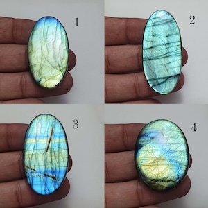 May include: Four oval-shaped labradorite gemstones with iridescent blue, green, and gold colors. The stones are numbered 1 through 4.