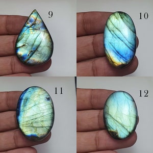 May include: Four labradorite gemstone cabochons in various shapes and sizes. The cabochons are a mix of green, blue, and gold colors with iridescent flashes. The cabochons are labeled with numbers 9, 10, 11, and 12.