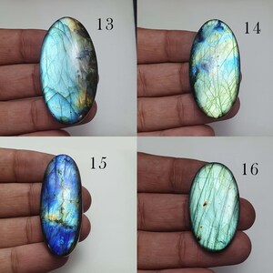 May include: Four oval-shaped labradorite gemstones with iridescent blue, green, and gold colors. The stones are labeled 13, 14, 15, and 16.