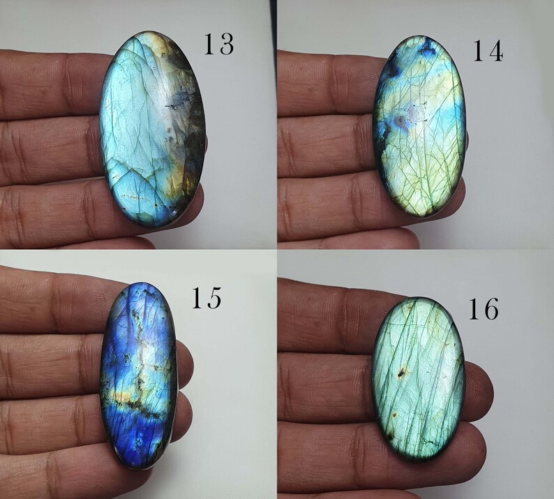 May include: Four oval-shaped labradorite gemstones with iridescent blue, green, and gold colors. The stones are labeled 13, 14, 15, and 16.