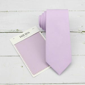 May include: A lavender tie with a fabric swatch labeled "David's Bridal".