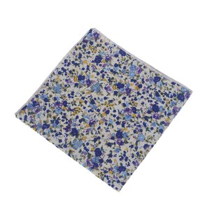 May include: A white pocket square with a blue and yellow floral pattern.
