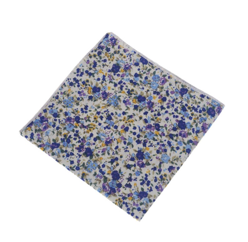 May include: A white pocket square with a blue and yellow floral pattern.