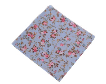 May include: A light blue fabric handkerchief with a floral pattern of pink and brown flowers on a white background.