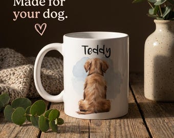 May include: A white ceramic mug featuring a watercolor illustration of a golden-colored dog seen from behind, with the name Teddy printed above it. The text Made for your dog. with a heart symbol is visible in the upper left corner of the image.