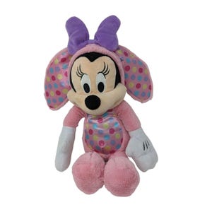 May include: Pink plush Minnie Mouse wearing a pink and white polka dot Easter bunny costume with purple ears and a bow.